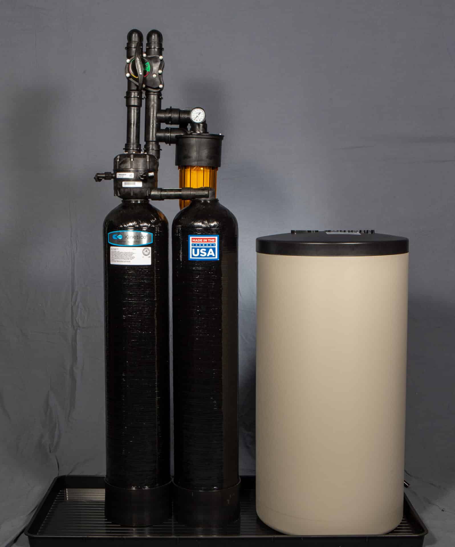 A diagram of a water softener showing the brine tank, mineral tank, and control valve